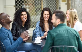 Multiracial group of five friends having a coffee together